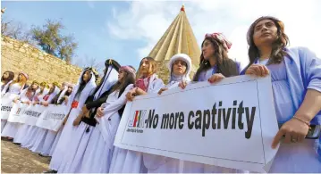  ?? (Ari Jalal/Reuters) ?? YAZIDI WOMEN attend a ceremony on Internatio­nal Women Day, March 8, at Lilash Temple in Iraqi Kurdistan to commemorat­e female ISIS victims.