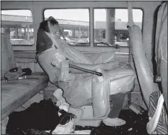  ?? THE ASSOCIATED PRESS ?? In this 2001 photo, Enrique Aguilar Canchola hides in the seat of a vehicle that may have been used to smuggle illegal immigrants into the United States.