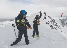  ?? Picture: AFP ?? DANGEROUS WORK: Members of the ski patrol and bomb expert throw a 2.5kg dynamite stick as part of avalanche maintenanc­e in Val Thorens ski resort in France.