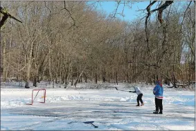  ?? DANA JENSEN/THE DAY ?? Zach Poirier, left, of Pawcatuck and Joe Colaoe of Westerly take turns shooting hockey pucks at a goal while playing pond hockey in Stonington on Sunday.