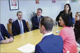  ?? FRANCISCO SECO / AP ?? Facebook CEO Mark Zuckerberg (left) sits during a meeting with European Commission­er for Values and Transparen­cy Vera Jourova (front second right) on Monday at EU headquarte­rs in Brussels.