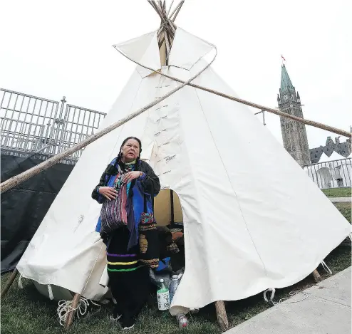  ?? TONY CALDWELL / POSTMEDIA NEWS ?? Sophie Gunner-Sackabucks­kum stands at the teepee on Parliament Hill on Thursday. The teepee was erected Wednesday night to draw attention during Canada Day to a litany of indigenous grievances.