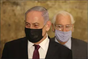  ??  ?? Israeli Prime Minister Benjamin Netanyahu (front) and U.S. Ambassador to Israel David Friedman address the media Thursday on the first night of Hanukkah at the Western Wall in Jerusalem. (AP/Emil Salman)