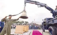  ??  ?? One of the bells is carefully lifted from the crate in preparatio­n for a handover ceremony at Villamor Air Base in Pasay City.