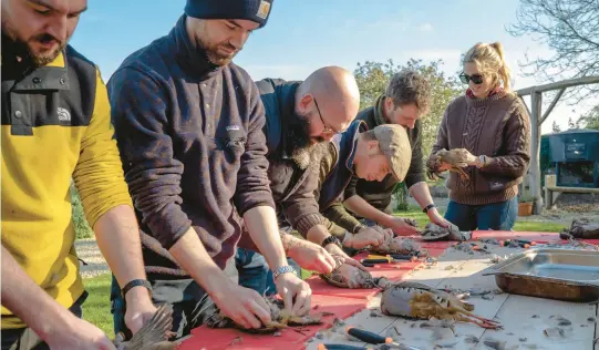  ?? ANDREW TESTA/THE NEW YORK TIMES 2022 ?? People butcher partridge and pheasant during a culinary class Nov. 12 at Firle Estate in Sussex, England.