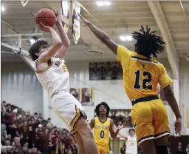  ?? RANDY MEYERS — FOR THE MORNING JOURNAL ?? Avon Lake’s Keegan Rudduck shoots over Jayden Parish of North Ridgeville during the second quarter Feb. 17.