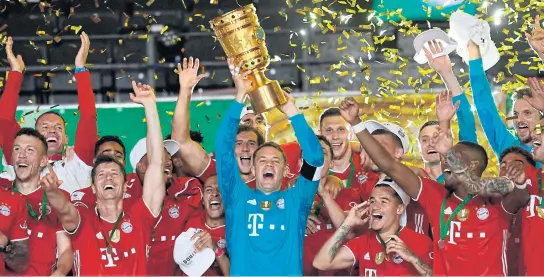  ?? AFP ?? Bayern Munich captain Manuel Neuer raises the German Cup to celebrate with his teammates at the Olympic Stadium in Berlin.