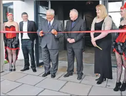  ??  ?? Chairman Dr Mike Peirce cuts the ribbon to open the buildi