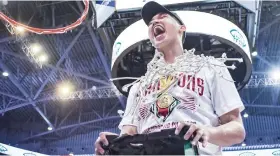  ?? / UAAP ?? STAR. Cebuano Carl Tamayo cuts down the nets after the UP Fighting Maroons won the UAAP men’s basketball title on May 13.