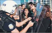  ?? AFP ?? Turkish riot police clash with protesters as they attempt to detain them in Istanbul on Tuesday, a day after a suicide bomb attack.