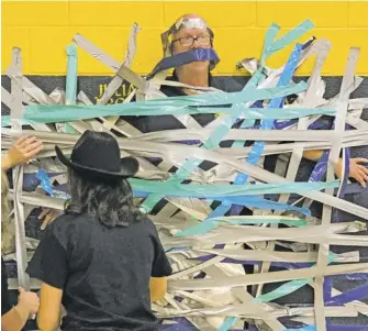  ?? PHOTOS BY DANI POND ?? RCHS Principal Jimmy Swindler was a good sport and agreed to be duct-taped to the wall to show his school spirit during homecoming week.