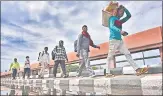  ??  ?? Migrant workers in Delhi walk back to their villages in Uttar Pradesh in March.