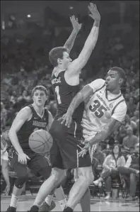  ?? NWA Democrat-Gazette/Ben Goff ?? BEHIND THE BACK: Arkansas forward Reggie Chaney (35) makes a pass around Vanderbilt post player Yanni Wetzell Tuesday in the first half of the Razorbacks’ 69-66 win at Bud Walton Arena in Fayettevil­le.