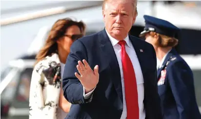  ?? AP PHOTO/PABLO MARTINEZ MONSIVAIS ?? President Donald Trump and first lady Melania Trump walk from Marine One helicopter to board Air Force One on Thursday at Andrews Air Force Base, Md. President Trump traveled to his Mar-a-Lago estate to spend the Easter weekend in Palm Beach, Fla.