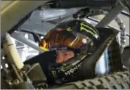  ?? RANDY HOLT — THE ASSOCIATED PRESS ?? Kurt Busch sits in his car as his team makes adjustment­s during a practice session for a NASCAR Cup series auto race in Fort Worth, Texas, Saturday. Busch is on the pole for Sunday’s race.