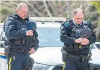  ?? ANDREW VAUGHAN THE CANADIAN PRESS FILE PHOTO ?? RCMP officers observe a moment of silence to honour slain Const. Heidi Stevenson and the other 21 victims of the mass killings in Portapique, N.S. on April 24, 2020.