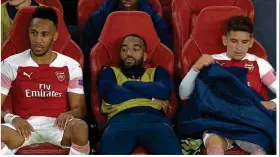  ??  ?? Bench warmer: Alexandre Lacazette (centre) looks cheesed off to sit this one out when he could have filled his boots
