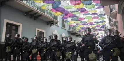  ?? AP PHOTO/CARLOS GIUSTI ?? Police block protesters from advancing to La Fortaleza governor’s residence in San Juan, Puerto Rico, on Sunday.