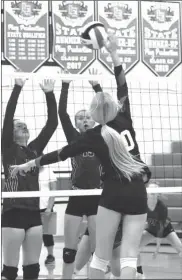  ?? Kelli Loos ?? At left, Arcadia/Loup City senior hitter Halie Kaslon sends a kill through the block of two Sandhills/Thedford defenders during the Rebel Invitation­al in Loup City on Saturday. The Rebels dropped their first game to South Loup then downed the Knights by winning in two sets and beat Ravenna in two sets to finish in fifth place. Leaders for the Rebels were Landri Loos with 2 ace serves and 9 assists, Tatum Kaputska with 2 ace serves and 3 kills and Ellie Oxford with 11 digs. For Sandhills/Thedford, Brea Branic had 8 kills and 1 ace along with Cylee Jameson who achieved 6 kills and 3 ace serves.