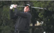  ?? Harry How / Getty Images ?? Phil Mickelson plays his shot from the 16th tee during the final round of the AT&amp;T Pebble Beach Pro-Am.