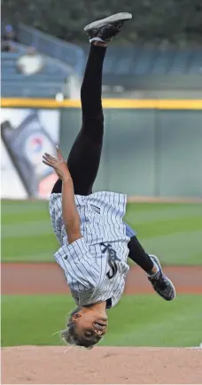  ?? DAVID BANKS, GETTY IMAGES ?? U.S. gymnast Ashton Locklear hams it up while throwing out the first pitch before a Cubs-White Sox game last month.