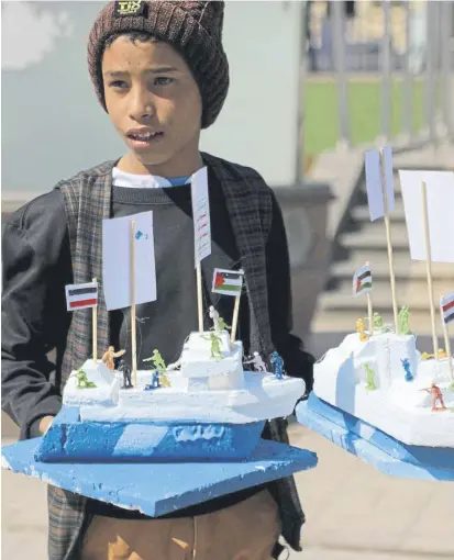  ?? PICTURE: MOHAMMED HUWAIS/AFP VIA GETTY IMAGES ?? A Yemeni boy sells models of the Galaxy Leader cargo ship, seized by Houthi fighters in November last year, in capital Sanaa