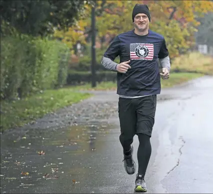  ??  ?? Derek Stevens runs along Crafton Boulevard in preparatio­n for the JFK 50-mile ultramarat­hon in Maryland to raise money for the 5p- Society. His daughter Helena was born with a rare genetic syndrome.