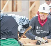  ?? CP PHOTO ?? Former U.S. president Jimmy Carter and a volunteer help build stairs for a homes for Habitat for Humanity in Edmonton on Tuesday. Carter was hospitaliz­ed for dehydratio­n Wednesday after working on the project.