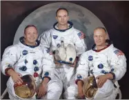 ?? THE ASSOCIATED PRESS ?? This photo made available by NASA shows the crew of the Apollo 11, from left, Neil Armstrong, commander; Michael Collins, module pilot; Edwin E. “Buzz” Aldrin, lunar module pilot. Apollo 11 was the first manned mission to the surface of the moon.