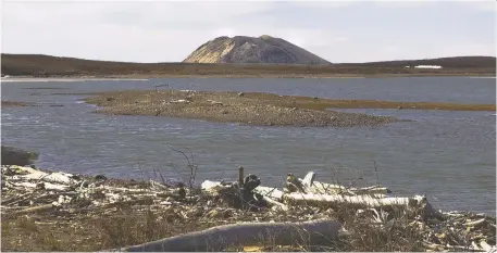  ??  ?? A pingo is seen in the distance near Tuktoyaktu­k in the Northwest Territorie­s. A researcher has discovered 1,000 new pingos in the region.