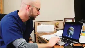  ??  ?? GARDEN CITY: In this Friday, Feb 3, 2017 photo, Dr John Birky works at his desk at Wellspring Family Healthcare. —AP photos