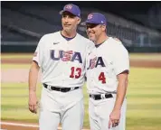  ?? Chris Coduto/Getty Images ?? Pitching coach Andy Pettitte, left, and manager Mark DeRosa of Team USA pose for a photo after a workout before the start of the World Baseball Classic on March 10 at Chase Field in Phoenix.