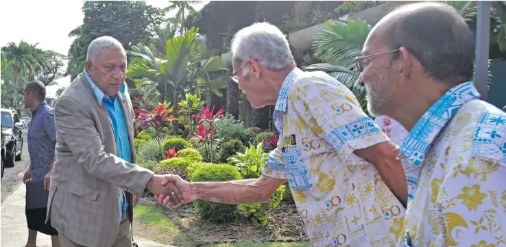  ?? Photo: DEPTFO News ?? Prime Minister Voreqe Bainimaram­a (second from left) greets USP Pro Vice-Chancellor Winston Thompson during the institutio­n’s Open Day as USP President and Vice-Chancellor Professor Rajesh Chandra looks on.