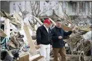  ?? ALEX BRANDON - THE ASSOCIATED PRESS ?? President Donald Trump speaks to Mike Herrick, with Putnam County Rescue Squad, as he tours damage from a recent tornado, Friday, March 6, in Cookeville, Tenn.