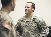  ?? JAMES ROBINSON/THE FAYETTEVIL­LE OBSERVER ?? Army Maj. Mathew Golsteyn, right, was notified Thursday by the Army that he will face one charge of murder.