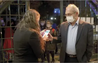  ?? AP photo ?? A man presents his “green passport,” proof that he is vaccinated against the coronaviru­s, this week at a theater performanc­e in Jerusalem where all guests were required to show proof of vaccinatio­n or full recovery from the virus.