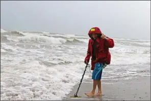  ?? AP/Miami Herald/DAVID SANTIAGO ?? Mike Squillace looks for metal in Dania Beach, Fla., on Monday as Tropical Storm Gordon roils the waters.