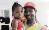  ?? DAVID GOODHUE/DGOODHUE@MIAMIHERAL­D.COM ?? Jermaine Toomer holds his daughter, Serenity, inside their Homestead house.