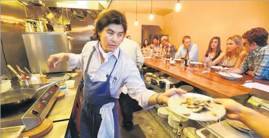  ?? Photograph­s by Mel Melcon Los Angeles Times ?? GARY MENES prepares a course at Le Comptoir in Koreatown. The $69 tasting menu features six courses based mostly on vegetables from a garden in Long Beach.