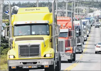  ??  ?? Big rigs roll across the Cape Sable Island Causeway in a memorial convoy for the late Roger James Comeau of Barrington on Aug. 24. Described as a legend, Comeau was on one of his weekly hauls to New York City and New Jersey when he passed away suddenly on Aug. 14 .