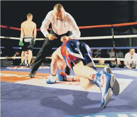  ??  ?? George Rhodes Jnr clambers up off the canvas after a heavy knockdown in the first round of his sixth-round stoppage loss against Dan West on Saturday