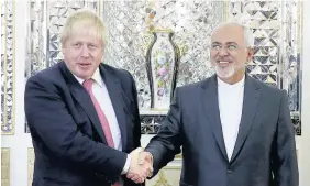  ??  ?? > Iranian Foreign Minister Mohammad Javad Zarif with Boris Johnson