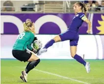  ?? CHARLES KING/STAFF PHOTOGRAPH­ER ?? Pride forward Alex Morgan, right, can’t quite get to the ball as Spirit goalkeeper Kelsey Wys secures it during Friday’s match in Orlando.