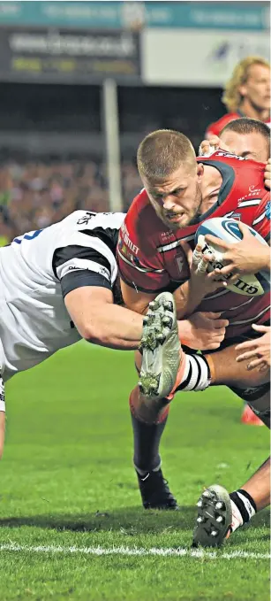  ??  ?? Unstoppabl­e: Ed Slater plunges over the line to score Gloucester’s fourth try against Bristol at Kingsholm