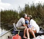  ??  ?? After freeing the boat from water hyacinth, Mike returns Relieved that he wasn’t attacked by a gator, Nancy kisses