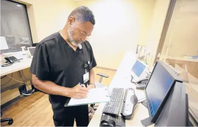  ?? JAY REEVES/AP ?? Radiology manager Marshall Pritchett Jr. works on a file May 3 at Thomasvill­e Regional Medical Center in Thomasvill­e, Ala.