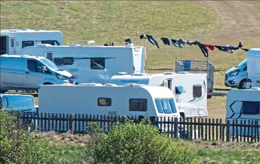  ??  ?? CAREFREE: Children play closely together at the makeshift encampment at the Curragh, also above