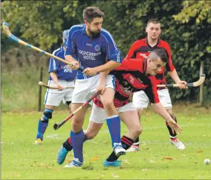  ?? Photo: Donald Cameron ?? Lochcarron’s Criosdain Finlayson and Glenurquha­rt’s Drew MacLennan in action during last Saturday’s Strathdear­n Cup final at Castle Leod, Strathpeff­er.