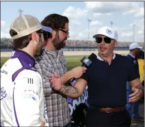  ?? DONALD PAGE/GETTY IMAGES ?? Singer and Trackhouse Racing Team co-owner Pitbull and driver Daniel Suarez speak to the media on the grid prior to the Ally 400 at Nashville Superspeed­way on June 20, 2021, in Lebanon, Tenn.