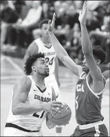  ?? Cliff Grassmick / Staff Photograph­er ?? Colorado’s Evan Battey looks to score against UCLA’S Chris Smith on Feb. 20.